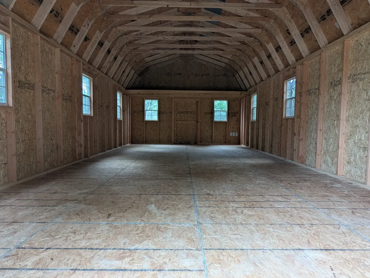 Custom storage shed interior with built in shelving and workbench in Texas